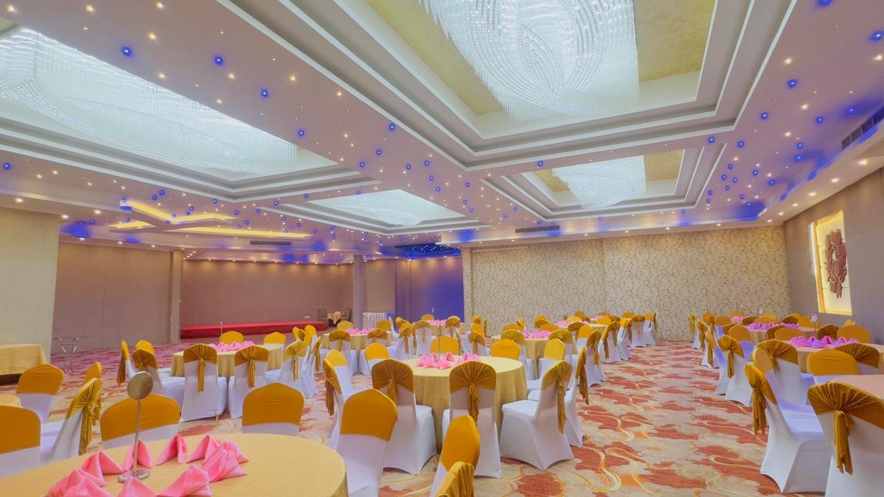 The Randilu Resort banquet hall with gold-sashed chairs, crystal chandeliers and a starlit ceiling